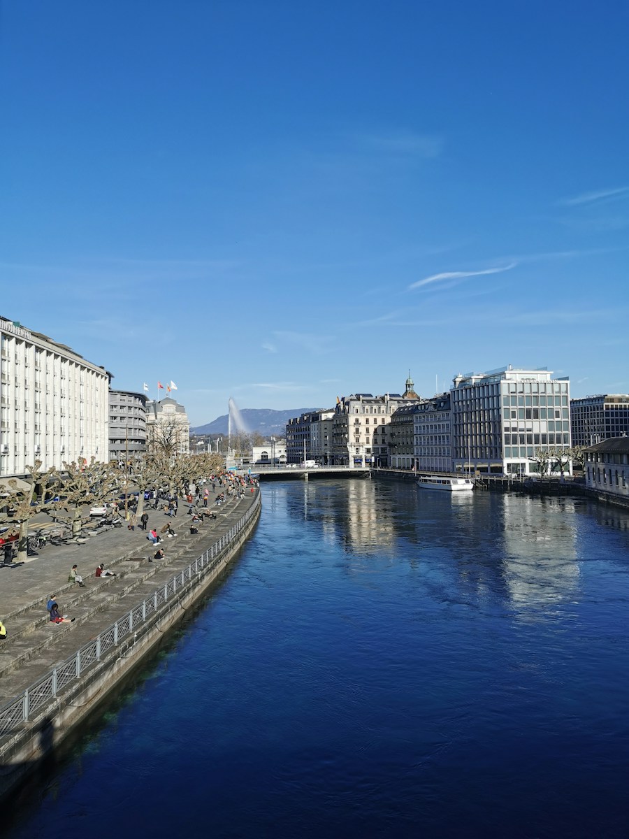 Photo by François Cardinaux white and gray concrete building near body of water during daytime